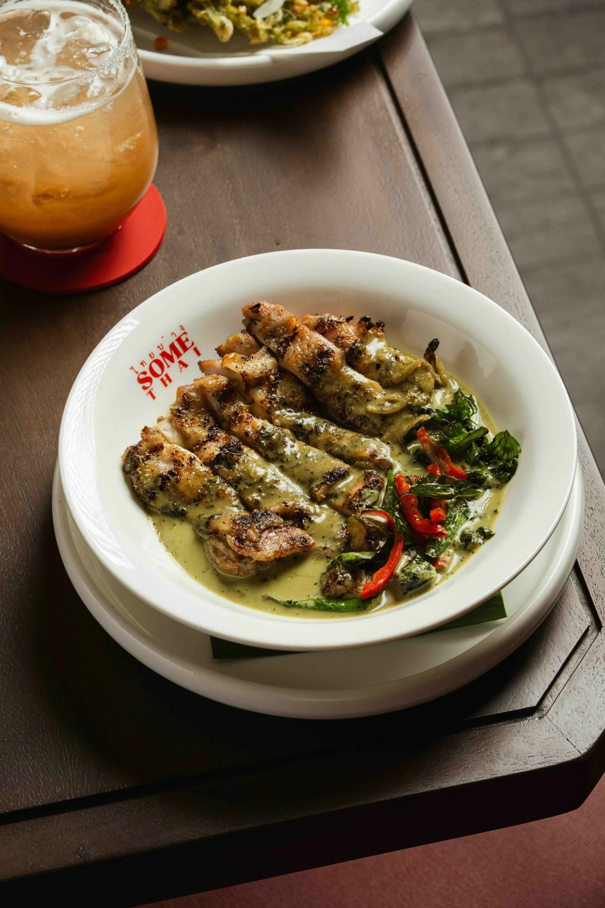 GREEN SCENE The Thai Grilled Green Curry Chicken pairs tender grilled chicken with a fragrant green curry sauce layered with herbs and aromatics (Photo: Some Thai)