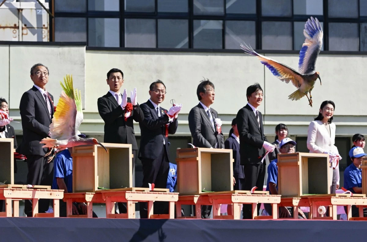 Japan's Crown Prince Akishino, second right, Crown Princess Kiko, right, and other officials watch a crested Ibis marked with painted wings released into wild during an event in Hakui, Japan, Sunday, May 31, 2026. (Japan Pool/Kyodo News via AP)