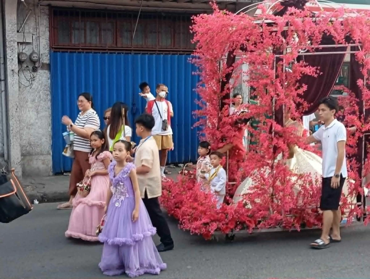 Young girls in their colorful and glittering gown form part of the Flores de Mayor participants in Binangonan, Rizal. (Photo by Nel Andrade/Manila)