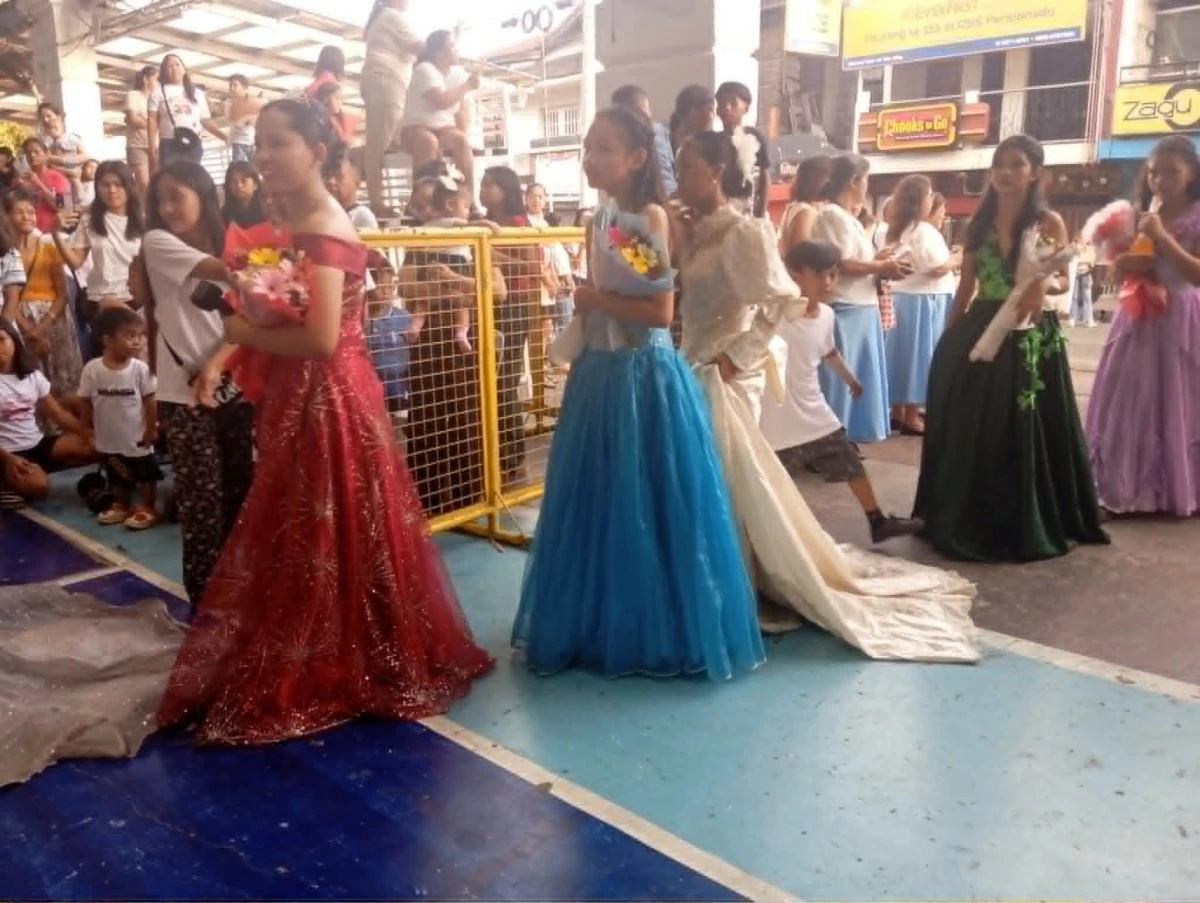 A showcase of gowns has become part of the Filipino tradition of Flores de Mayo, held in honor of the Virgin Mary. (Photo by Nel Andrade/Manila Bulletin).