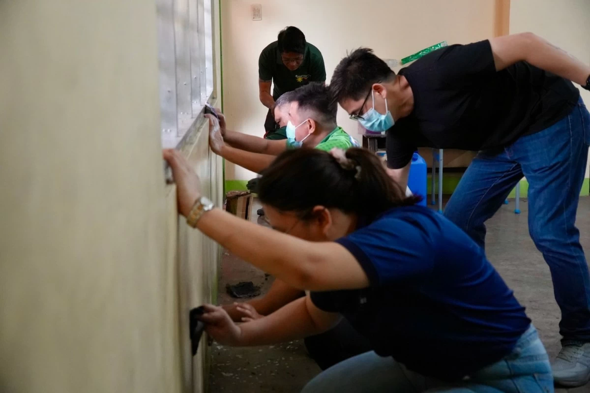 OVP volunteers repaint worn classroom walls as part of campus preparations for the opening of classes. (OVP photo) 