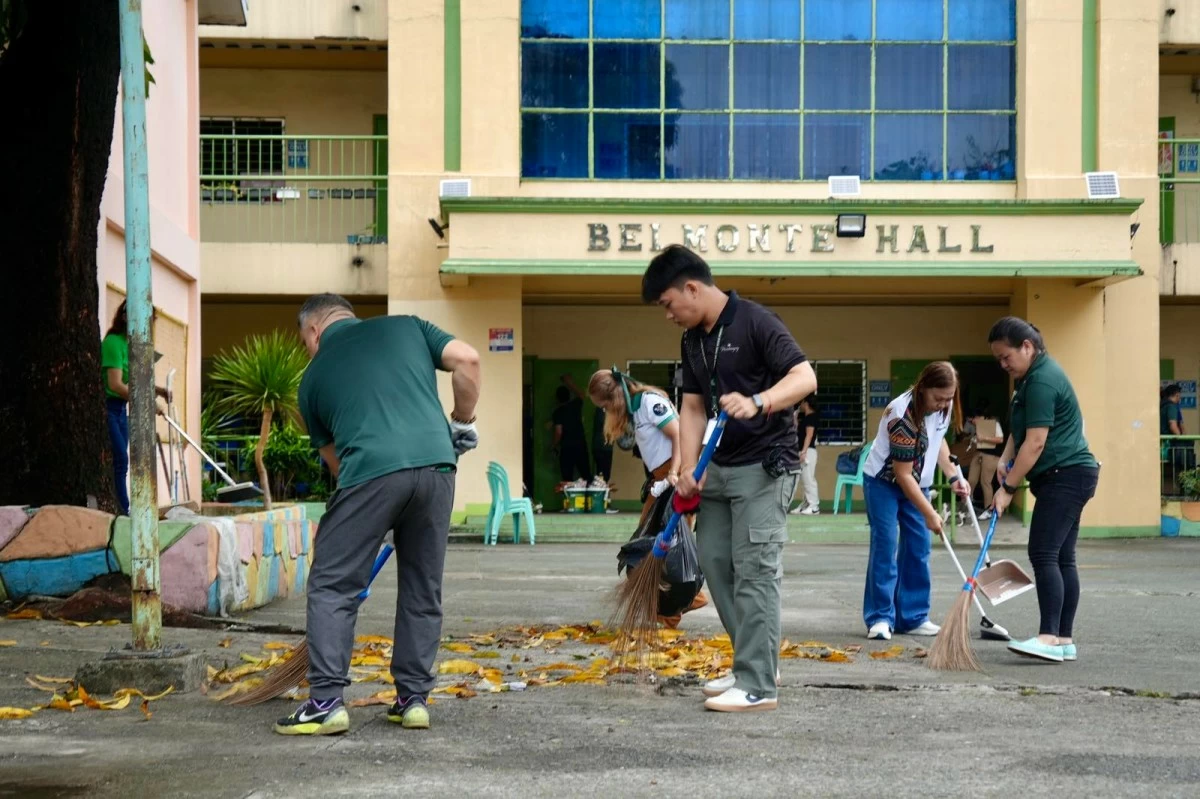Volunteers from the OVP sweep the school grounds as part of ongoing cleanup efforts ahead of the opening of classes. (OVP photo) 