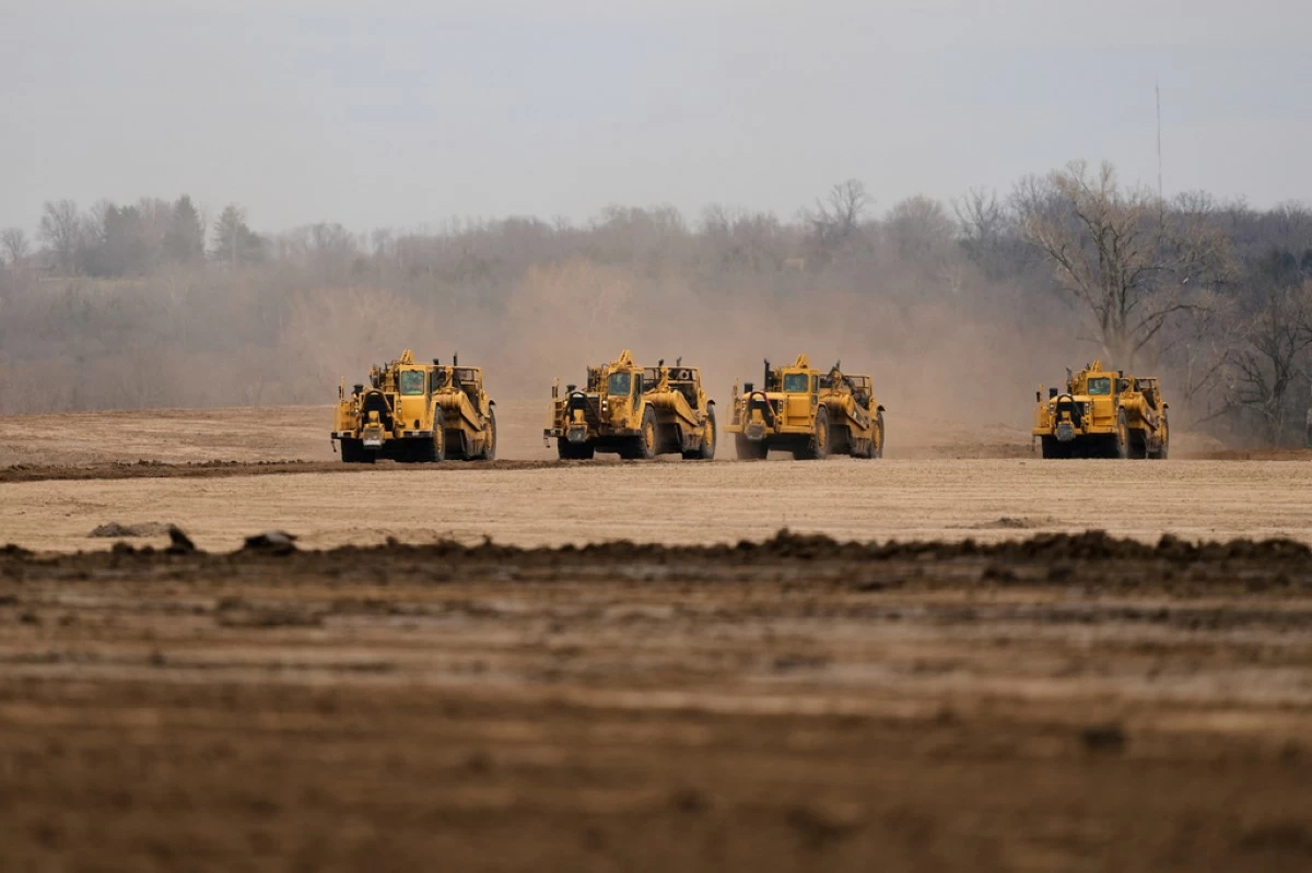 Earth movers prepare a site for a 2.5 million square foot AI data center March 24, 2026, in Independence, Mo. (AP Photo/Charlie Riedel, File)