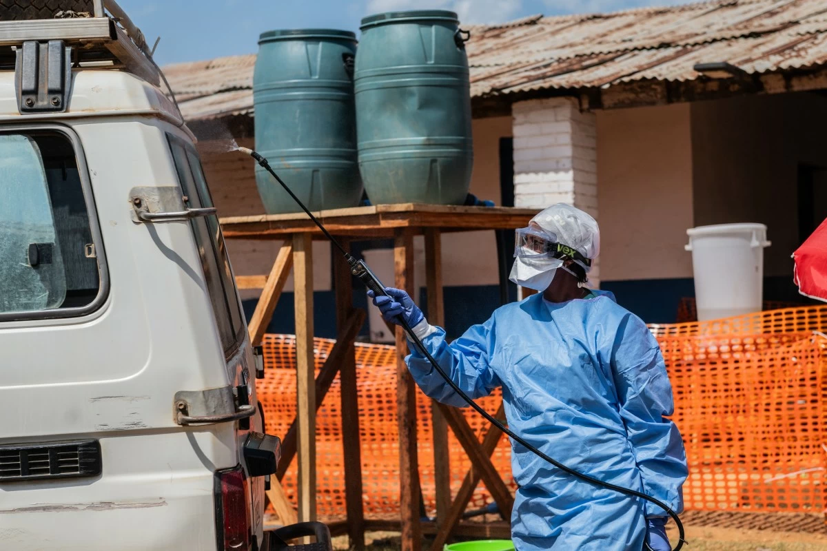 A health worker disinfects an ambulance at the Mongbwalu treatment center that transported a suspected Ebola patient in Mongbwalu, Congo, Friday, June 5, 2026. (AP Photo/Moses Sawasawa)
