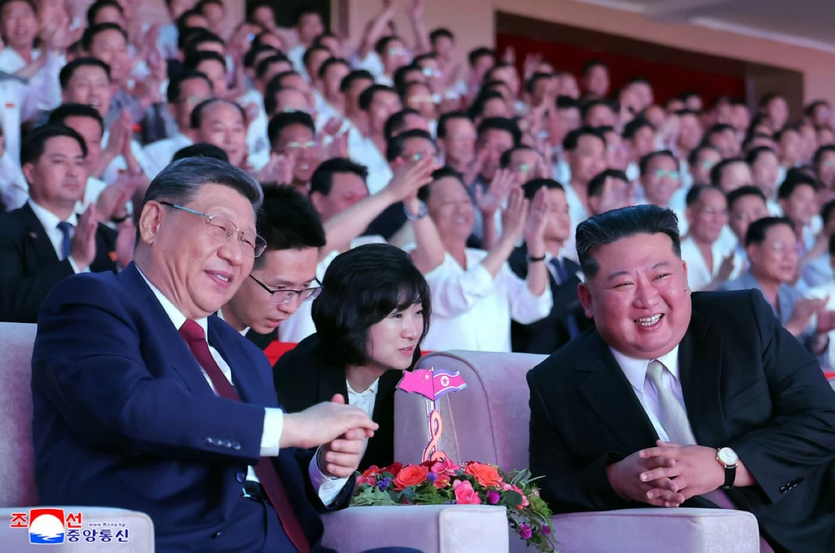 In this photo provided by the North Korean government, North Korean leader Kim Jong Un, right, and Chinese President Xi Jinping, left, smile as they watch welcome performance at Pyongyang Gymnasium in Pyongyang, Monday, June 8, 2026. (Korean Central News Agency/Korea News Service via AP)