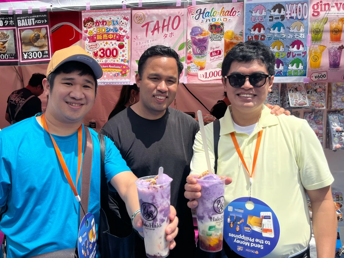 Visitors from the Philippines hold cups of 