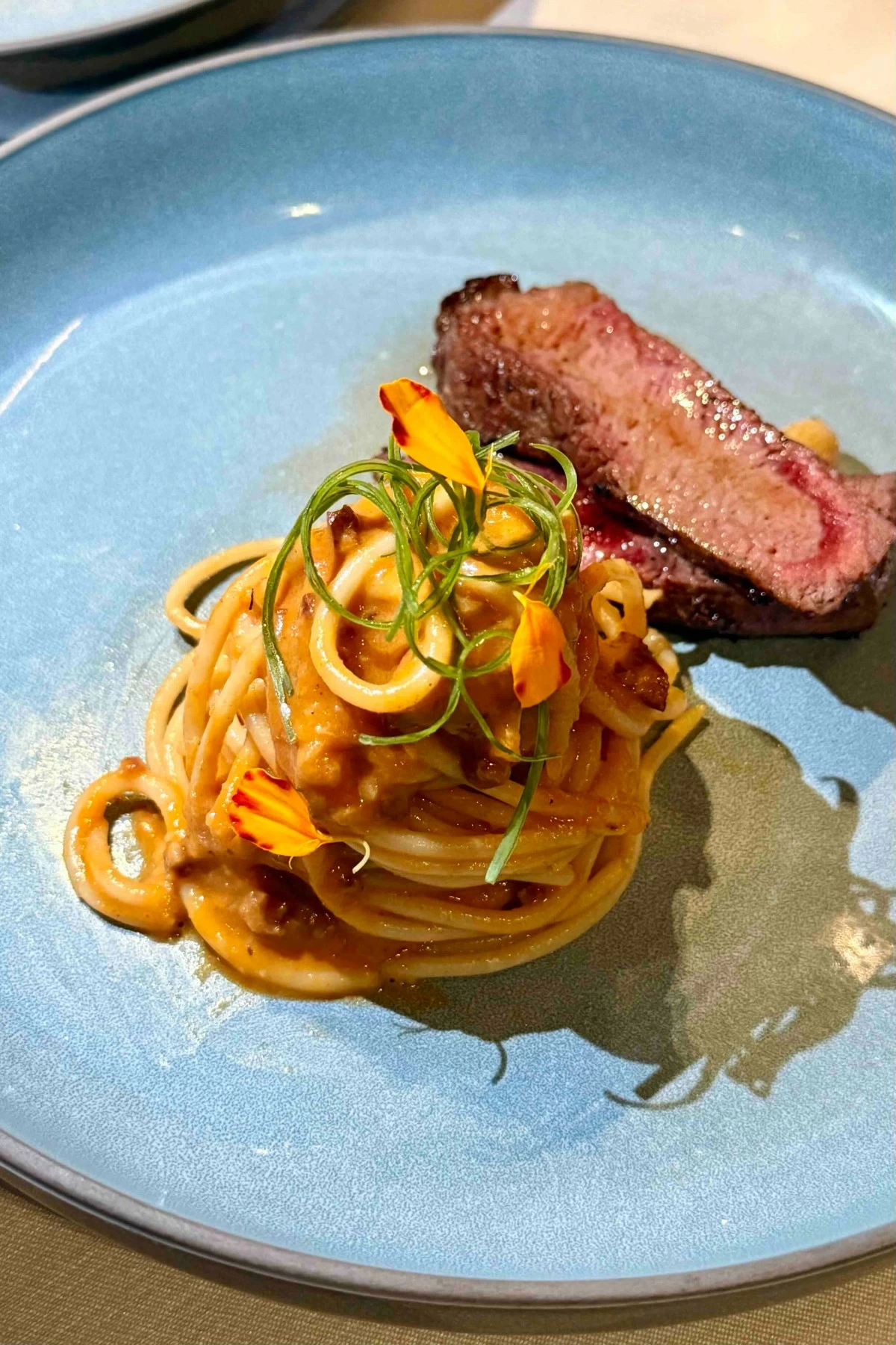 PASTA AND BEEF Chorizo vodka pasta paired with wagyu ribeye combines smoky, savory flavors with the rich tenderness of premium beef (Photo: Carmelo's)