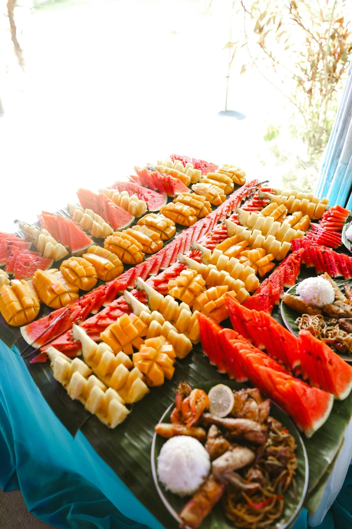 ISLAND FEAST Fresh fruits, seafood, grilled meats, rice, and pancit come together for a spread fit for island living (Photo: Magic Liwanag)