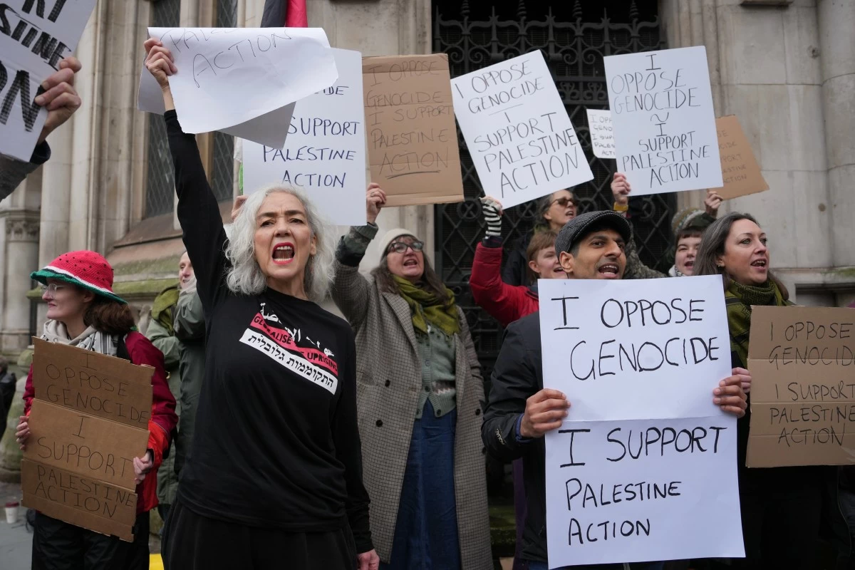 FILE - Supporters of Palestine Action stage a protest outside the Royal Court of Justice in London, Friday, Feb. 13, 2026. (AP Photo/Kin Cheung, File)