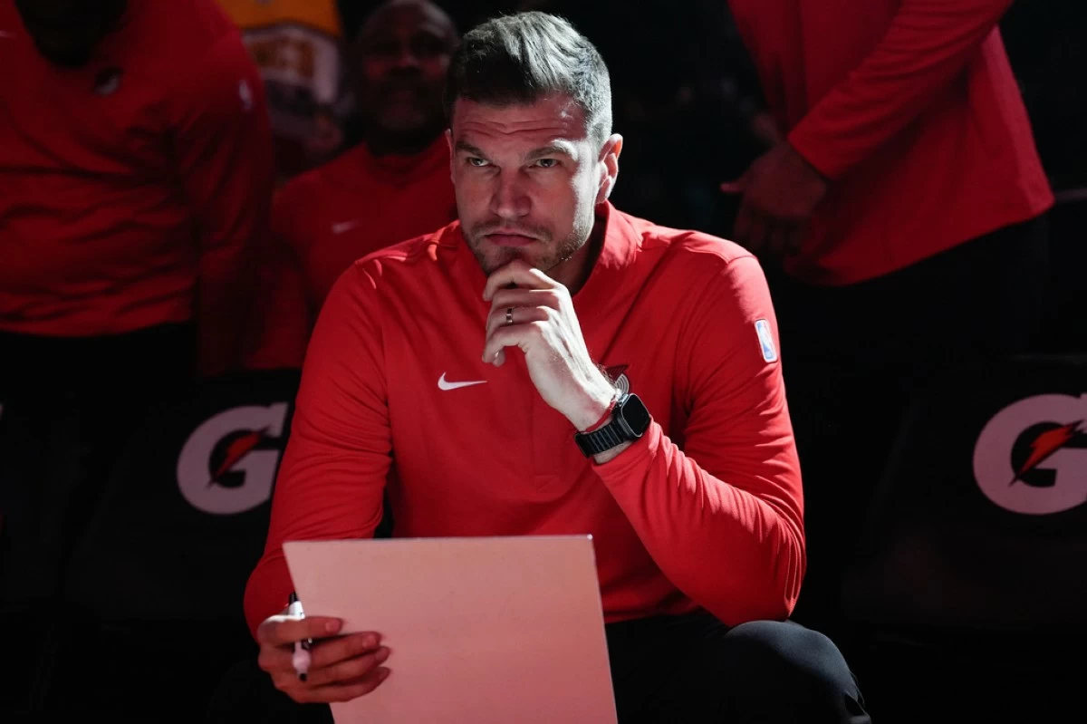 FILE - Portland Trail Blazers interim head coach Tiago Splitter listens during introductions before an NBA basketball game against the Brooklyn Nets, March 23, 2026, in Portland, Ore. (AP Photo/Jenny Kane, File)