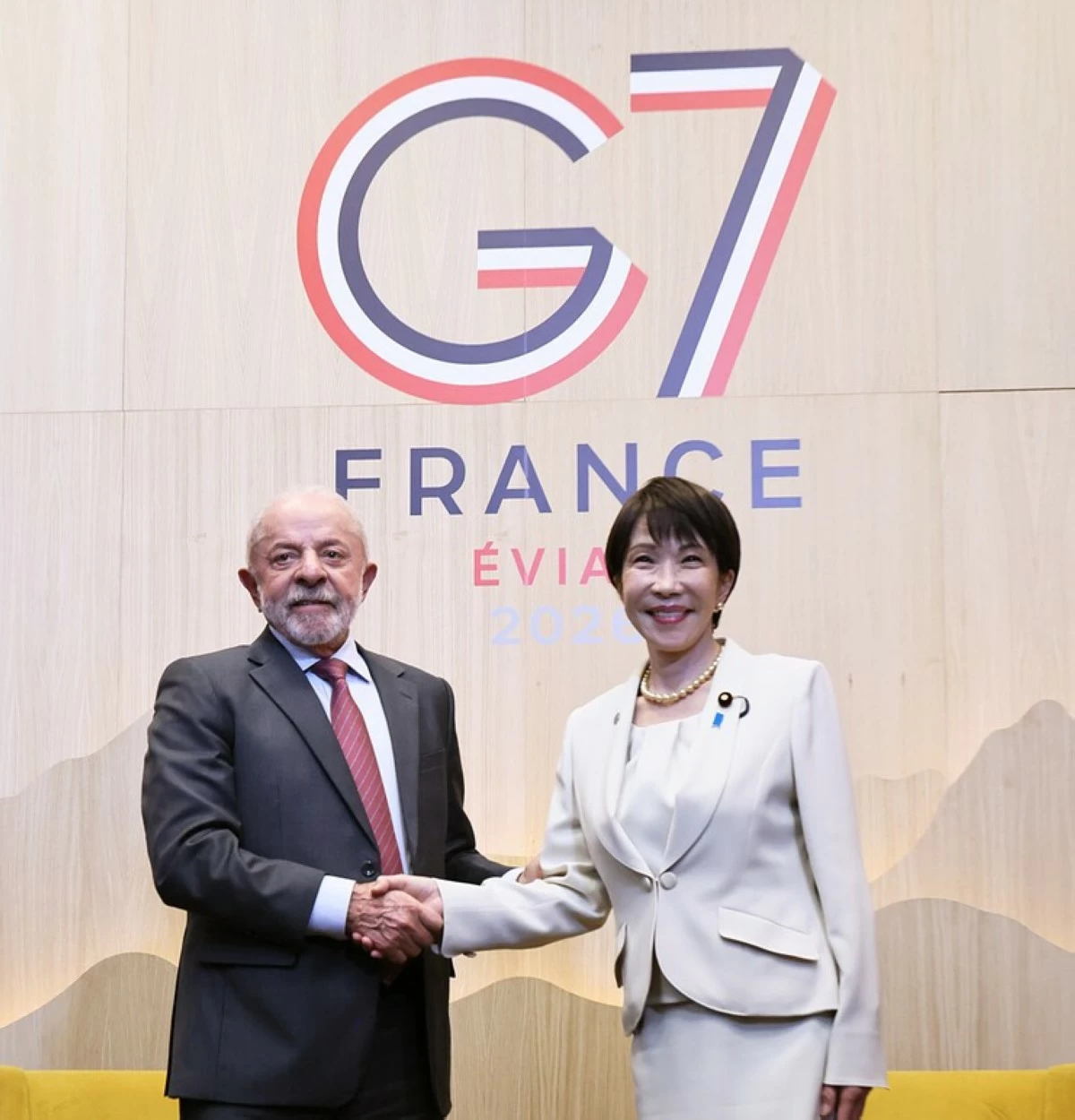 Japanese Prime Minister Sanae Takaichi (right) and Brazilian President Luiz Inacio Lula da Silva shake hands at their meeting in Evian, eastern France, on Tuesday. (Pool photo)