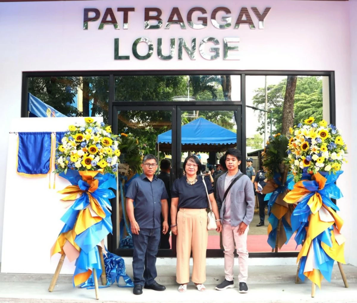 The family of Patrolman Harwin Curtney Baggay poses in front of the Pat Baggay Lounge at Camp Karingal during its inauguration. (Photo courtesy of QCPD)
