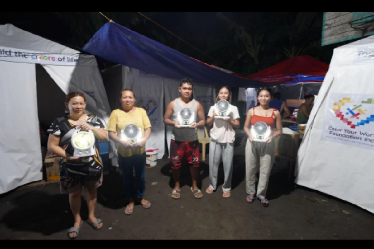 Residents in Purok 20, Barangay Lagao in General Santos City show the solar-power lamps they received from Color Your World Foundation on June 14, 2026.