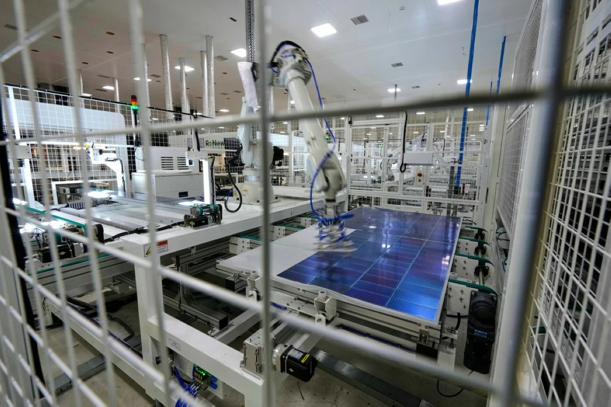 FILE - A robot places solar cells on a glass panel at a ReNew manufacturing plant on the outskirts of Jaipur, India, Aug. 21, 2025. (AP Photo/Manish Swarup, File)