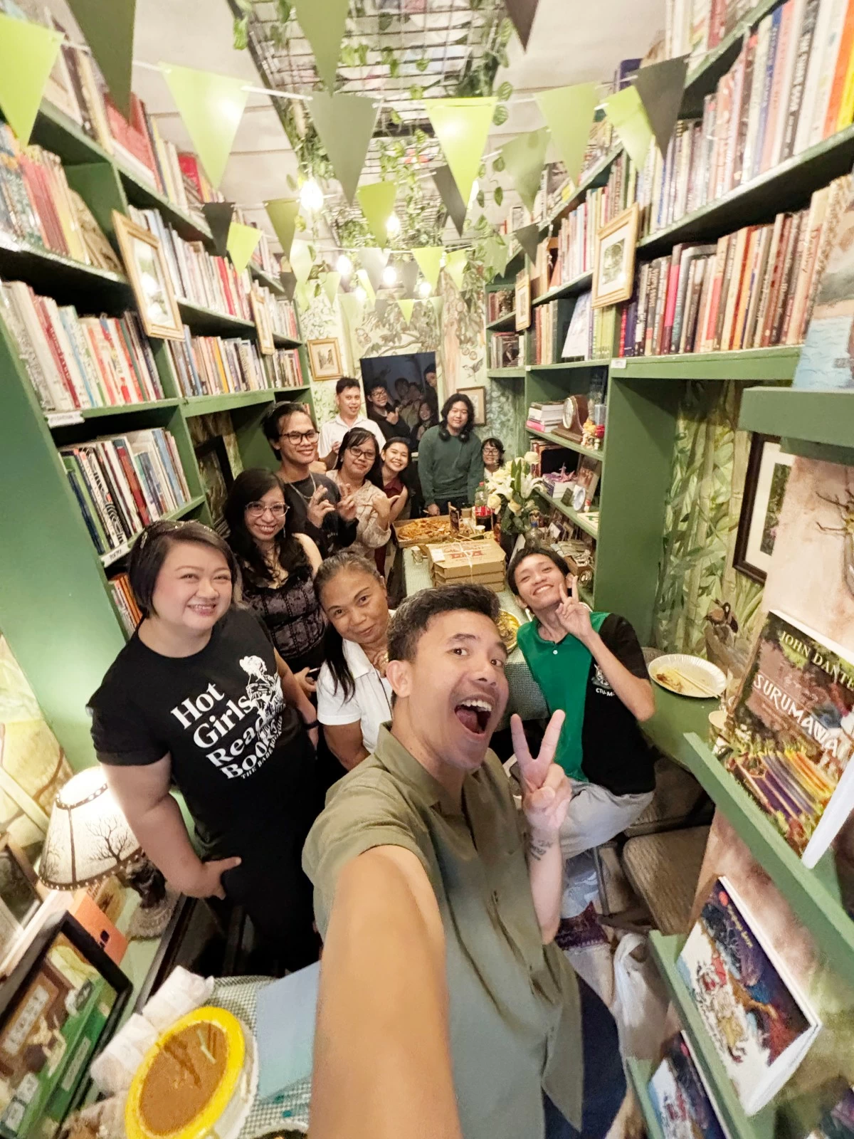 FRUITFUL YEAR — Owner Donald Villamero (center) celebrates the bookshop’s first year anniversary with the Lost Books Cebu community.
