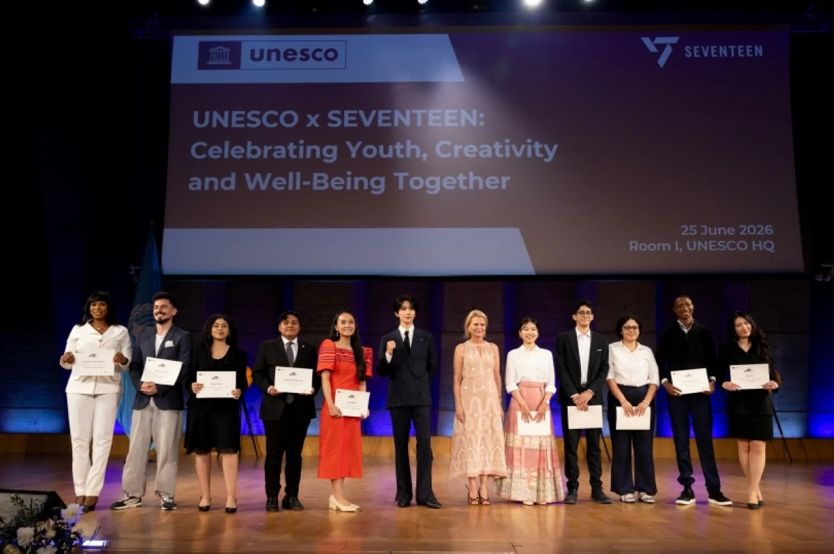 Seventeen's Joshua (sixth from left) with the Philippines Mary Rose Pagador (fifth from left), one of the founders of Project Palabasa, at the Seventeen X UNESCO event in Paris (Pledis Entertainment) 