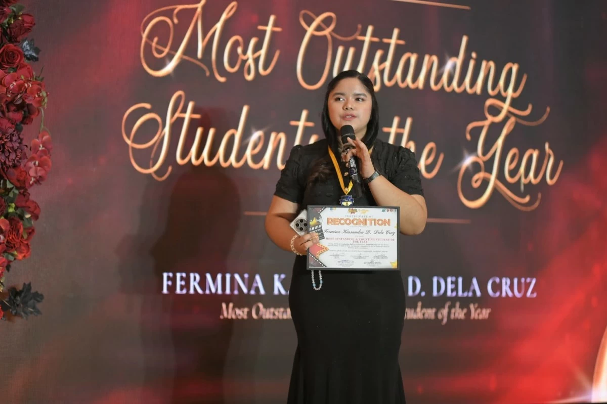 Fermina delivers her speech while holding her Most Outstanding Accounting Student of the Year recognition, reflecting her faith, sense of purpose, and commitment to help her family and others.