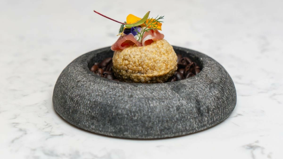 FIRST HARVEST Harvest opens the seven-course degustation with a puri shell filled with cocoa espuma, cured ham, and freshly grated Batangas cacao nibs (Photo: The Westin Manila)