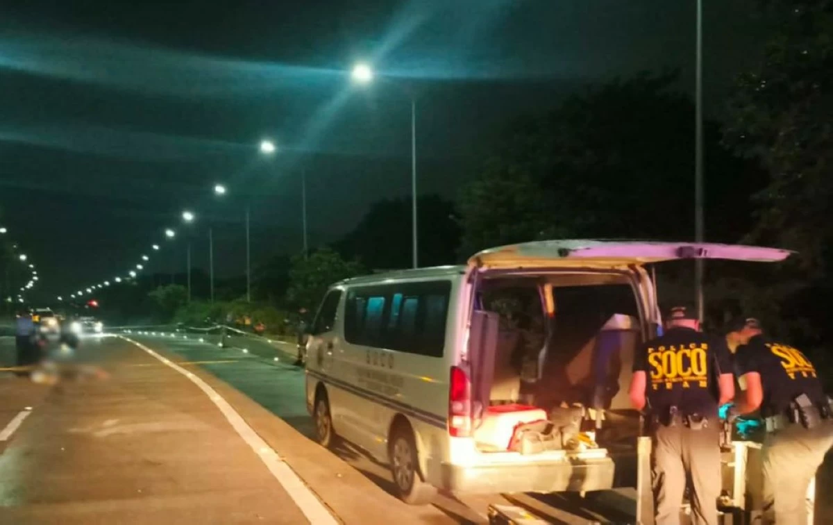 SOCO personnel processing the crime scene in Carmona where a victim initially believed to have died in a hit-and-run was later found, through an autopsy, to have been fatally shot (Photo from Cavite PPO/MANILA BULLETIN)