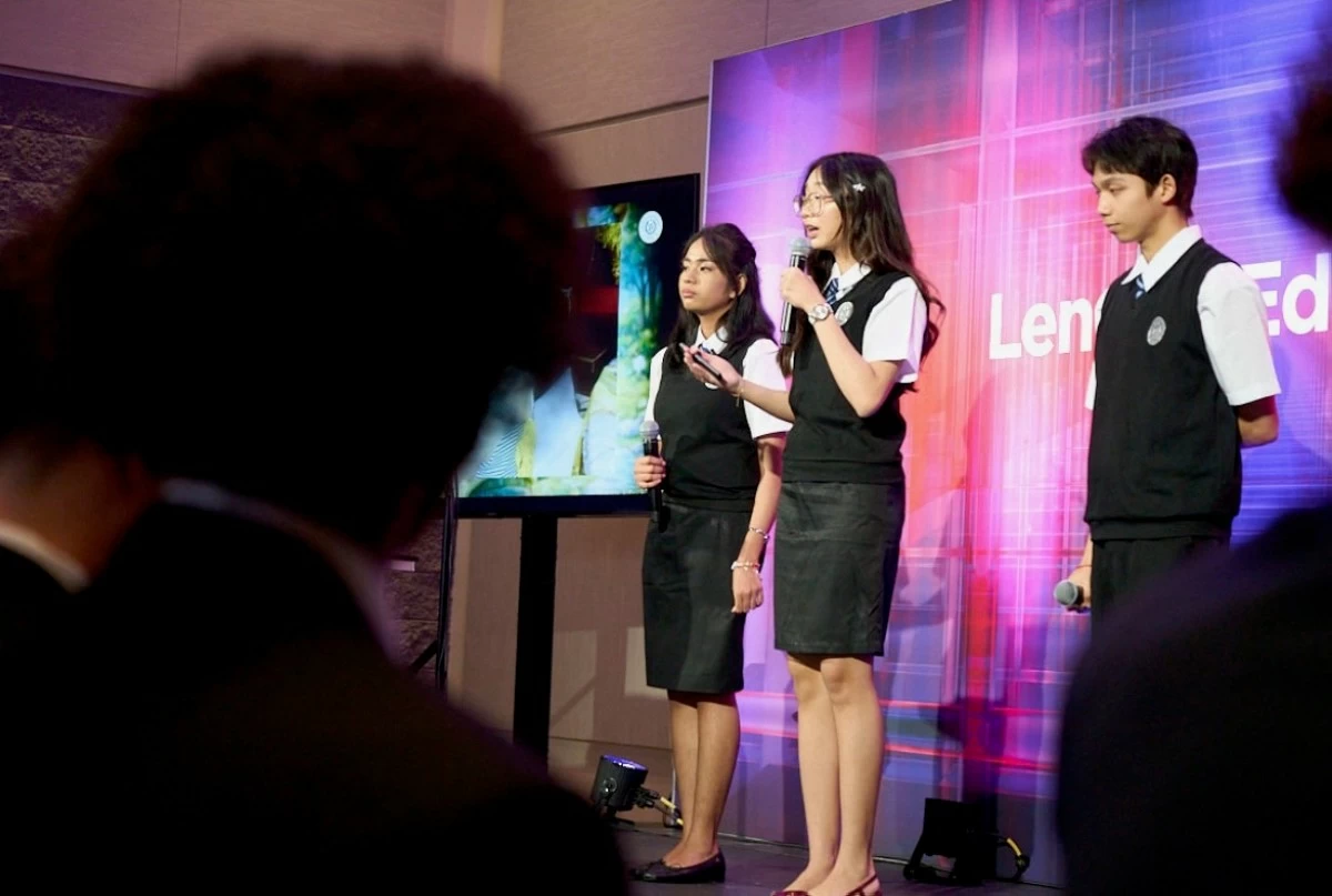 Viktoria Binuya, Alexandra Manungay, and Jo Justin Ong present their AI-powered innovation 'ReSiklo' during the SparkTalk session at the AI Pavilion and on the Lenovo stage.