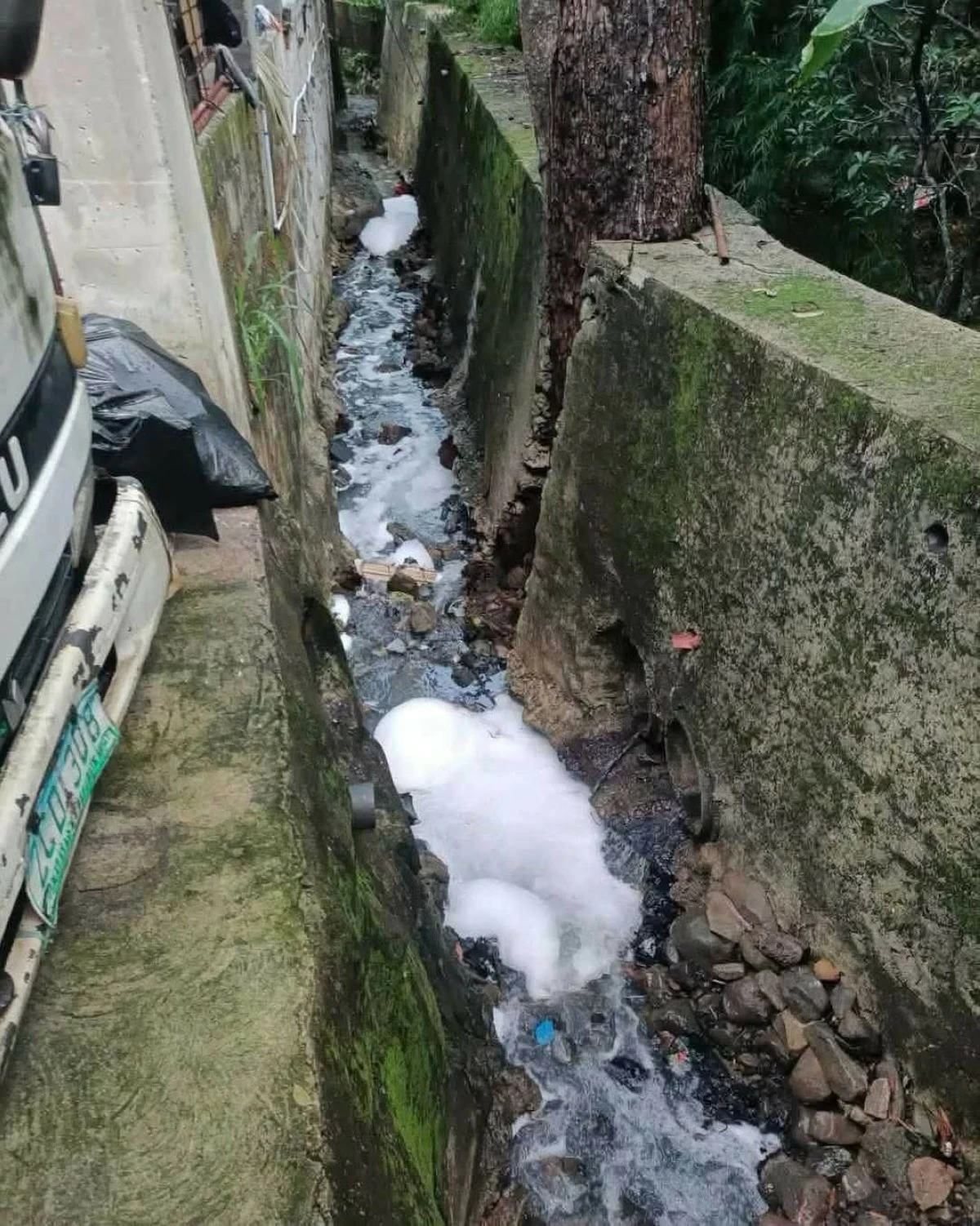 The Antipolo City government issues an Environmental Violation Ticket to a resident following a foam overflow in a portion of Sitio Oreta that reached several nearby homes. (Photos from Mayor Jun Ynares)