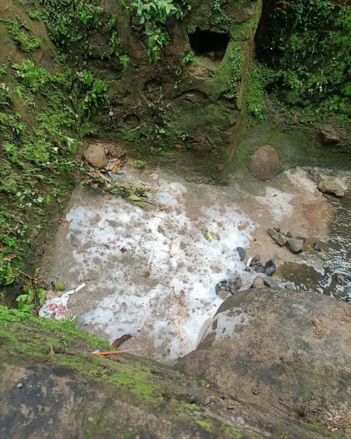 The Antipolo City government issues an Environmental Violation Ticket to a resident following a foam overflow in a portion of Sitio Oreta that reached several nearby homes. (Photos from Mayor Jun Ynares)