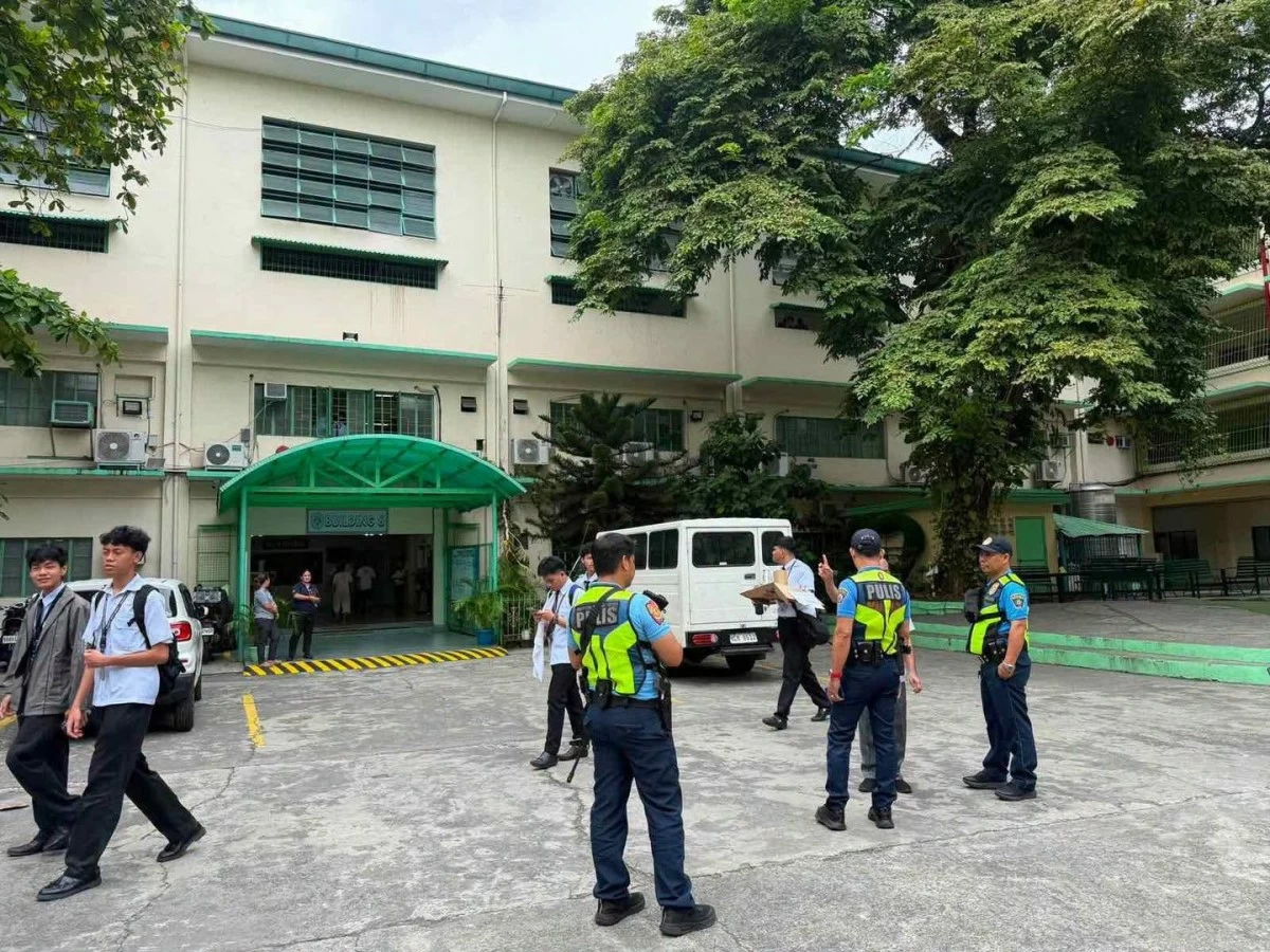 
Personnel from the Pasay City Police, together with school officials, conducts an inspection of the Pasay City East High School premises after receiving a report of an alleged gun threat. (Photo from Pasay PIO)
