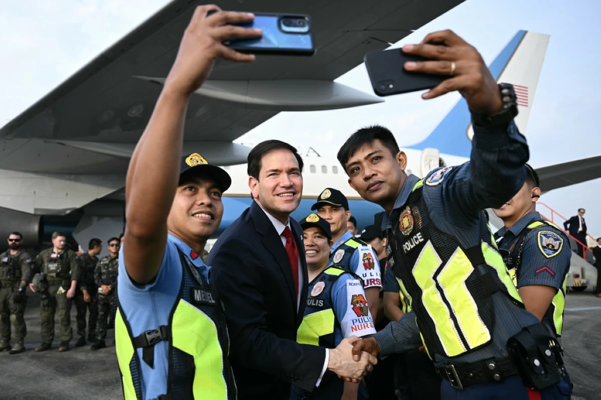 Secretary of State Marco Rubio meets Philippine police and others security personnel before departing from Ninoy Aquino International Airport in Manila, Philippines, following his visit to attend the Association of Southeast Asian Nations (ASEAN) Foreign Ministers Meeting,Thursday, July 23, 2026. (Brendan Smialowski/Pool Photo via AP)