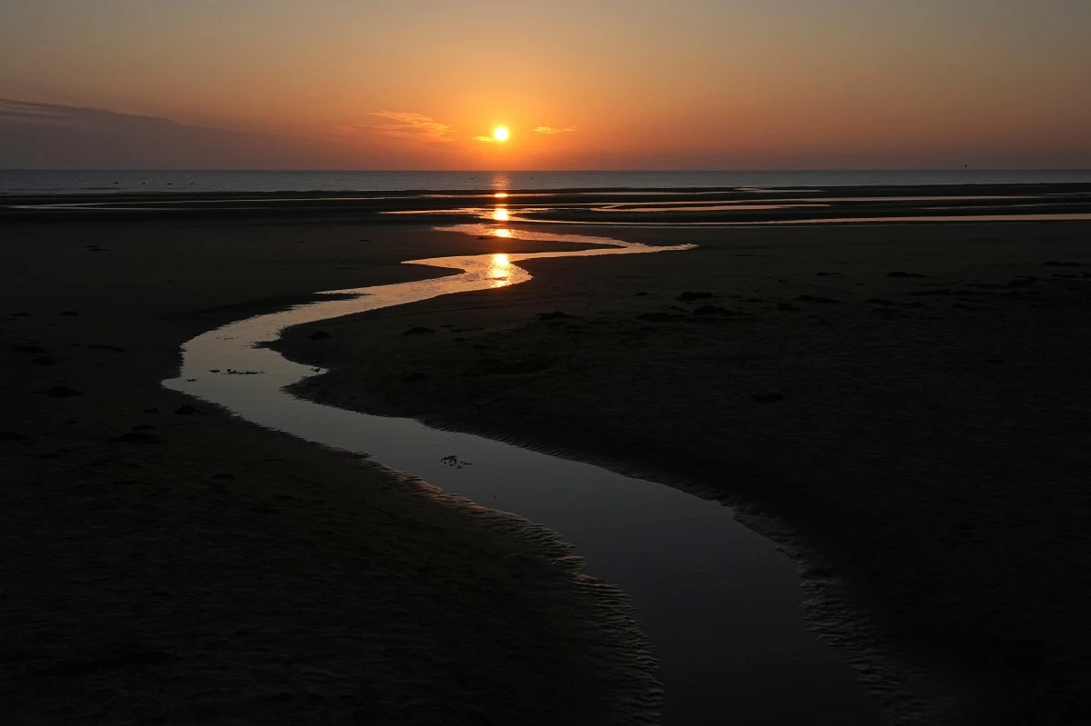 FILE - Sun rises over Omaha Beach near Colleville-sur-Mer Normandy, Thursday, June 6, 2024. (AP Photo/Laurent Cipriani, file)