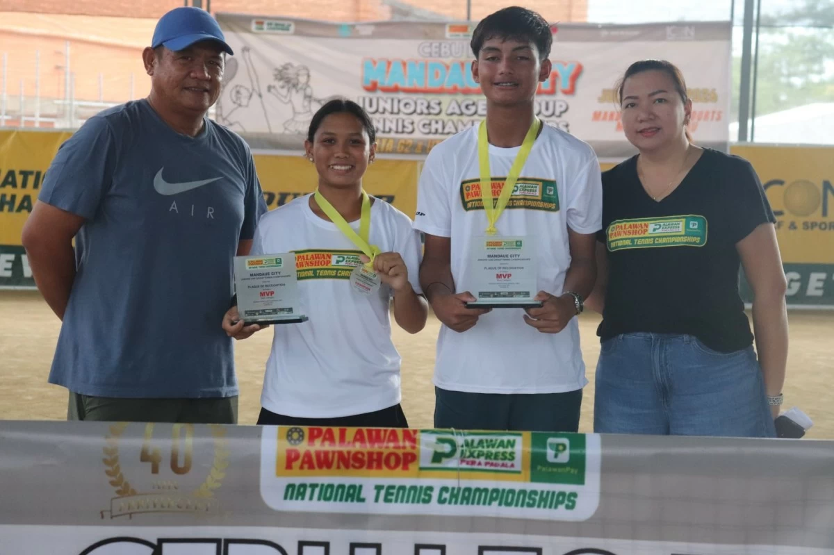 Nadine Seno and Morris Matthew show off their trophies and medals after capturing top honors in the Mandaue juniors tennis tournament. Flanking them are Palawan tennis coach Allain Rey Lao (left) and tournament referee Karen Arellano.