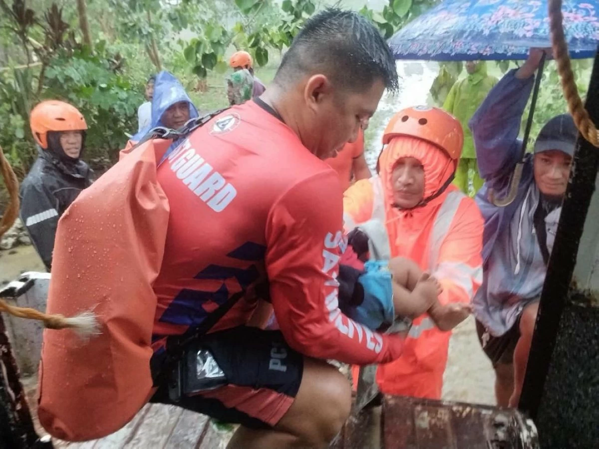 
RESIDENTS from Sitio Pannao, Barangay Tabbac, Buguey, Cagayan affected by typhoon Kiyapo are evacuated by Coast Guard District Northeastern Luzon personnel. (Coast Guard photo)


