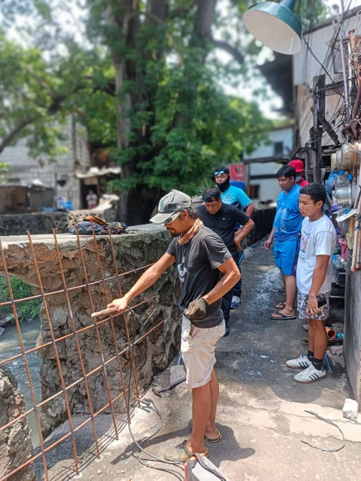 A metal barrier is being installed on a riprap hole leading to a creek in Barangay North Signal Village, Taguig, on July 28 (Photo from Barangay North Signal Village's Facebook account) 
