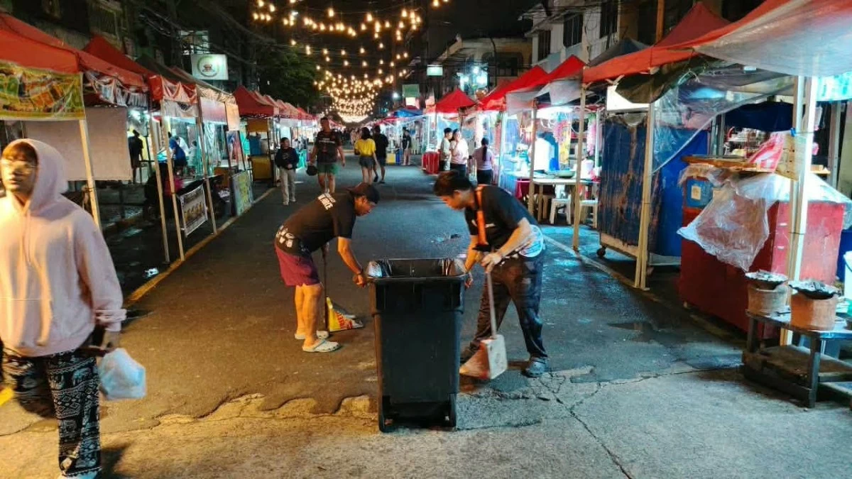 Vendors clean up Fusion Alley along I. Delos Reyes Street after operations, as the city enforces nightly sanitation in the busy university belt food strip. (Photo courtesy of Fusion Alley Food Park - Sampaloc Manila)