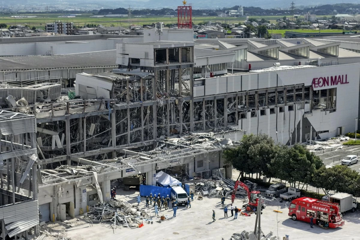 In this aerial image taken with a drone, responders work outside AEON Mall Kumamoto after an explosion occurred following an earthquake, in Kashima, Kumamoto Prefecture, southern Japan, Thursday, July 30, 2026. (Koji Harada/Kyodo News via AP)