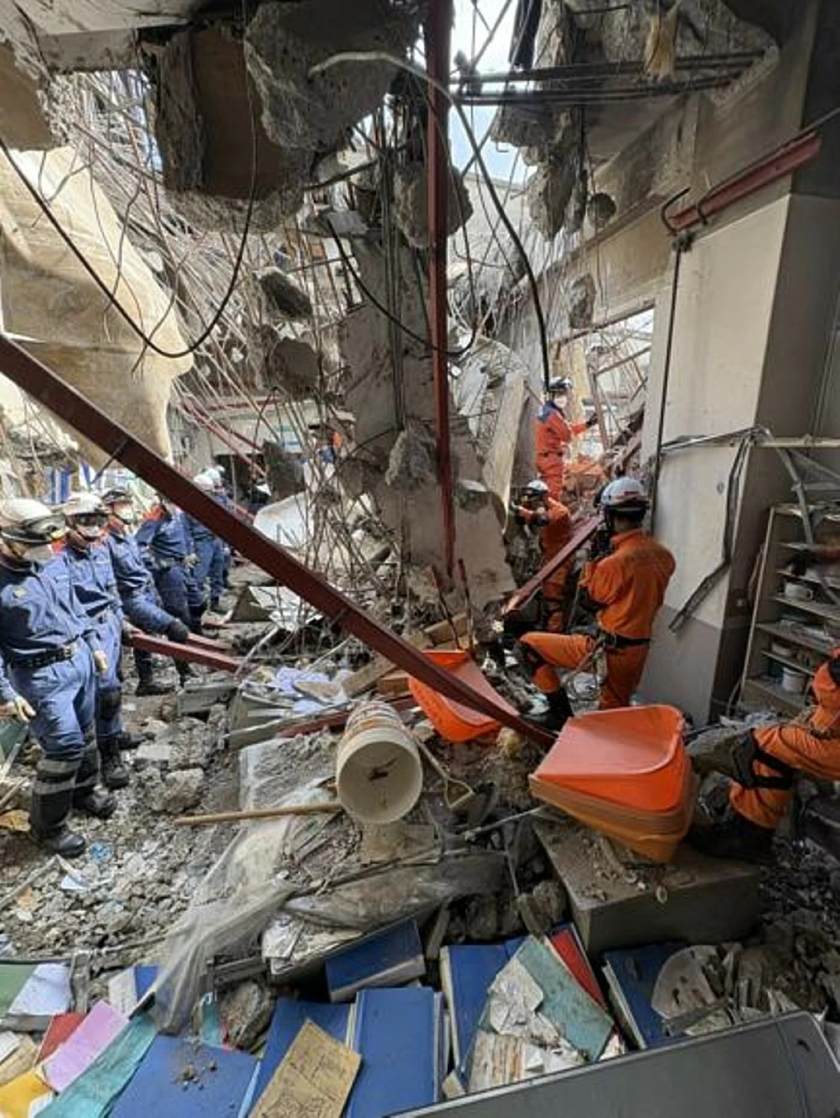 This image provided by Japan's Fire and Disaster Management Agency shows firefighters during rescue operation inside Nippon Paper Industries factory, which was damaged by an earthquake, in Yatsushiro, Kumamoto Prefecture, southern Japan, Thursday, July 30, 2026. (Japan's Fire and Disaster Management Agency via AP)