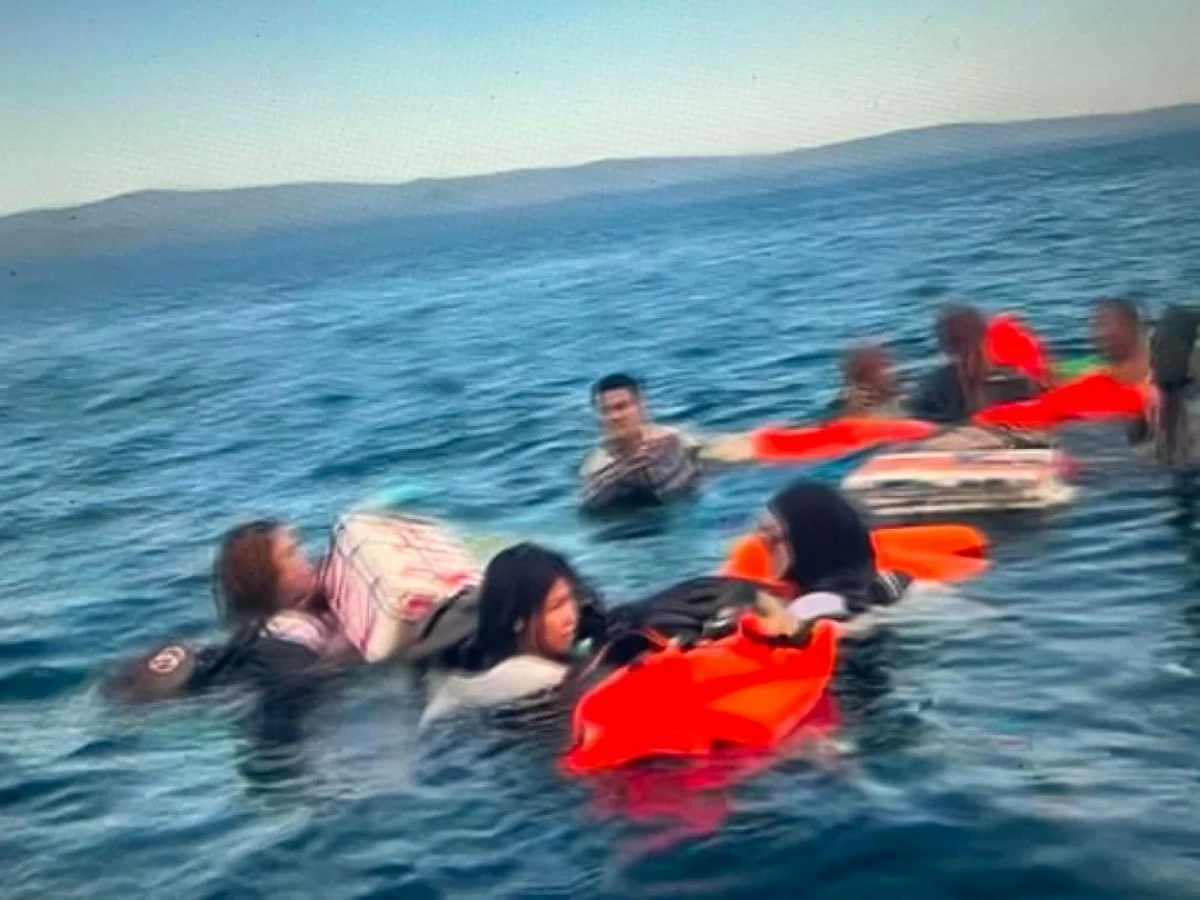 PASSENGERS of a sunken boat in Zamboanga City float in life vests as they await rescue on Sunday. (Photo via Liza Jocson)
