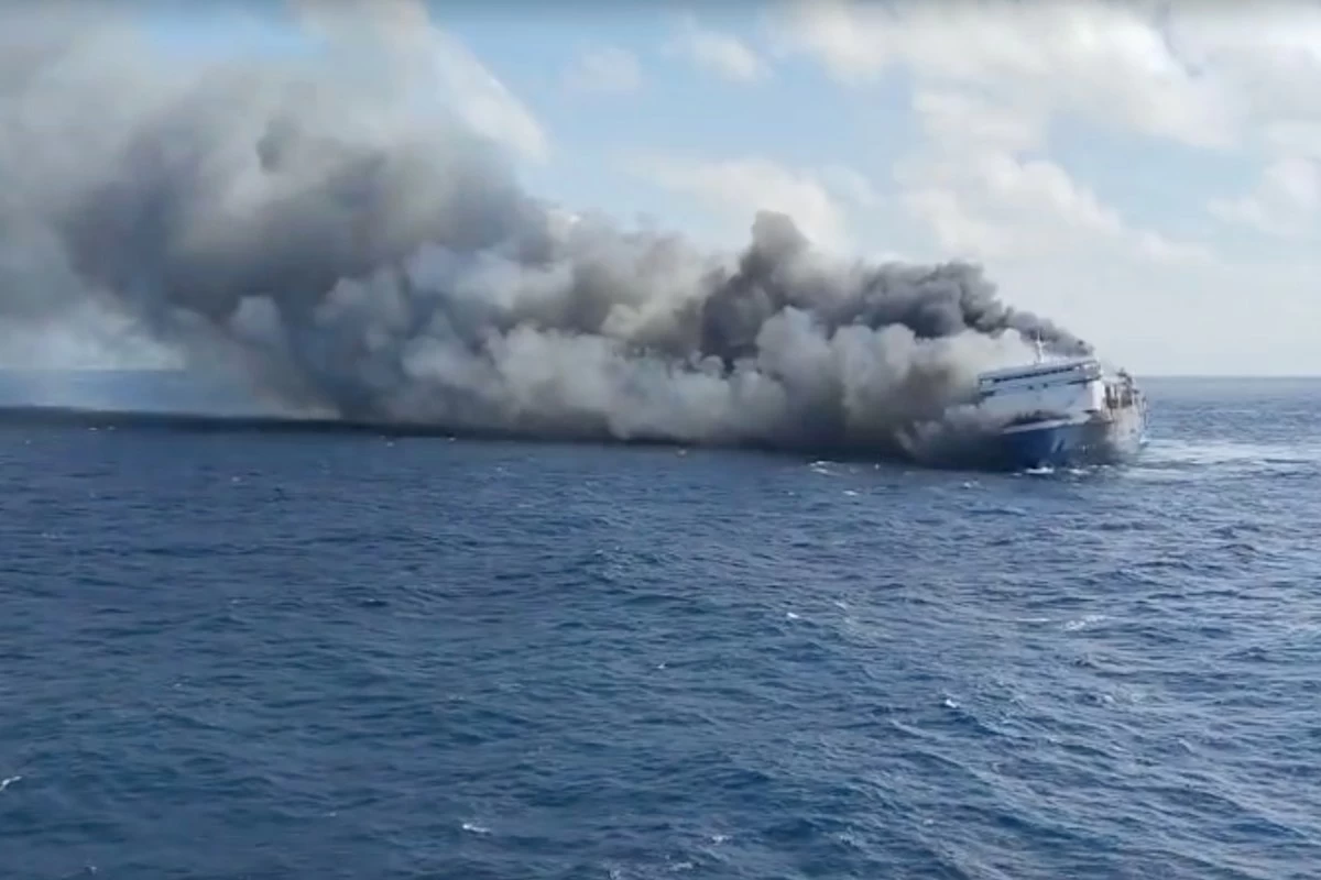 In this photo made from video released by the Indonesian National Search and Rescue Agency (BASARNAS) on Sunday, Aug. 2, 2026, smoke billows from passenger ship Mutiara Santosa 2 after it caught fire in the waters off Madura Island, Indonesia. (BASARNAS via AP)