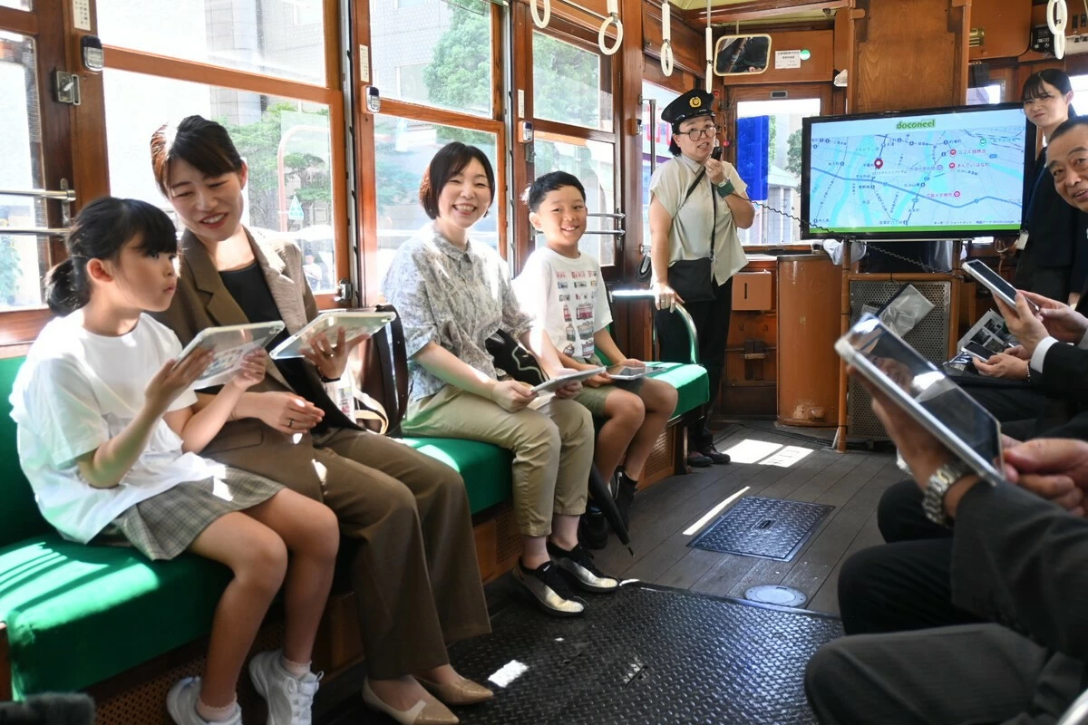 Participants take a test ride on a streetcar that survived the atomic bombing of Hiroshima before the start of a tour of the city on Sunday.