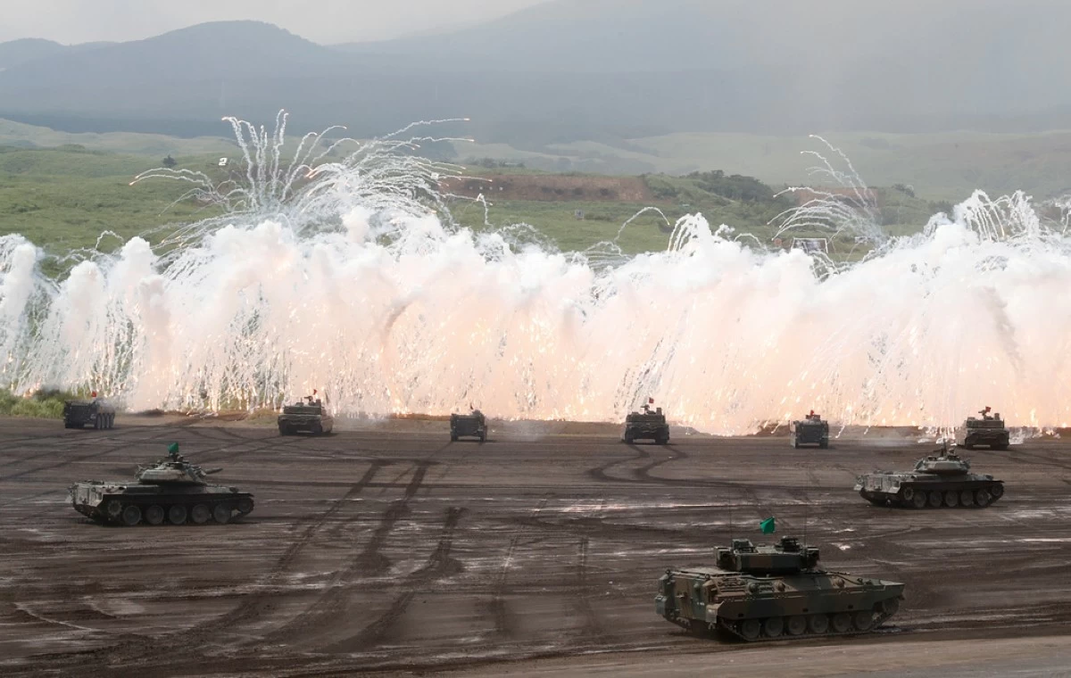 Japan Ground Self-Defense Force's tanks flare up a smoke screen during an annual live firing exercise at Higashi Fuji range in Gotemba, southwest of Tokyo on Aug. 24, 2017. (AP Photo/Eugene Hoshiko, File)