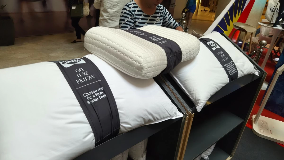 Visitors take part in a personalized pillow matching activity designed to help them find the right pillow for their sleep preferences. (Photo: Rodmill G. Lopez)