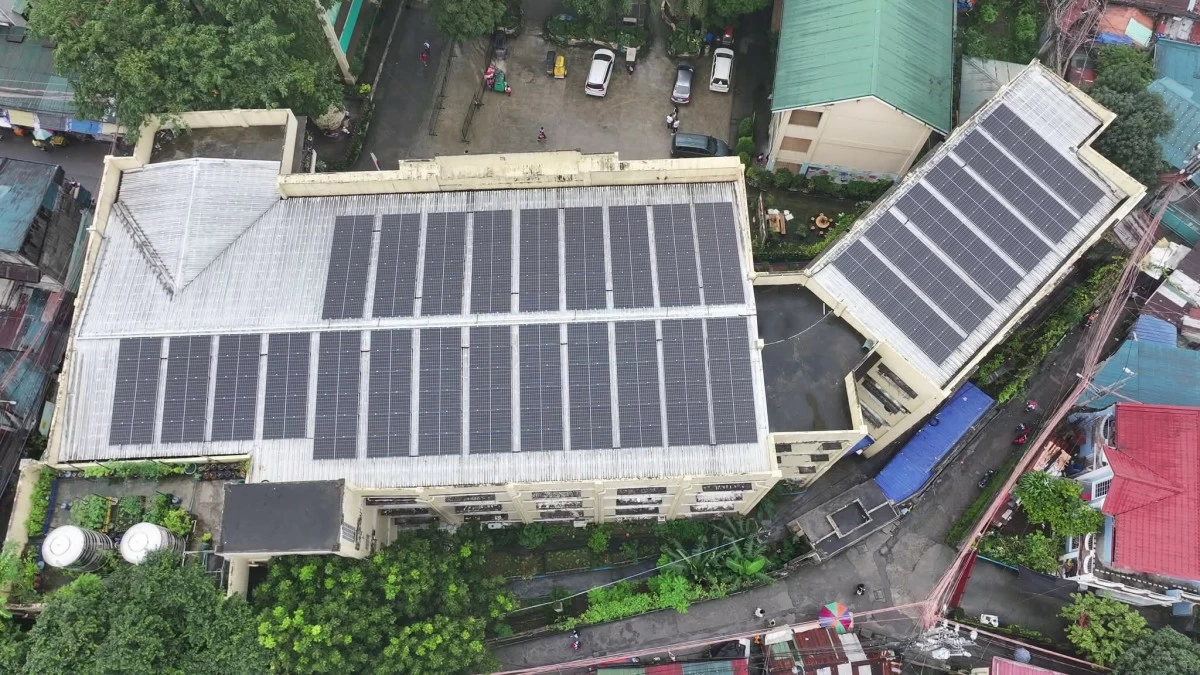 Quezon City Mayor Joy Belmonte leads the ceremonial lighting of the solar power system at San Agustin Elementary School, which has 170 solar panels and is expected to save around P930,000 in electricity costs annually. (Photo courtesy of the Quezon City government)