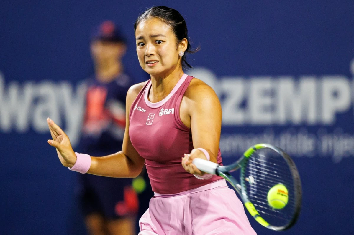 Alexandra Eala, of the Philippines, returns the ball from Belinda Bencic, of Switzerland, during a round of 16 match at the National Bank Open tennis tournament in Toronto, on Sunday, Aug. 9, 2026. (Keito Newman/The Canadian Press via AP)
