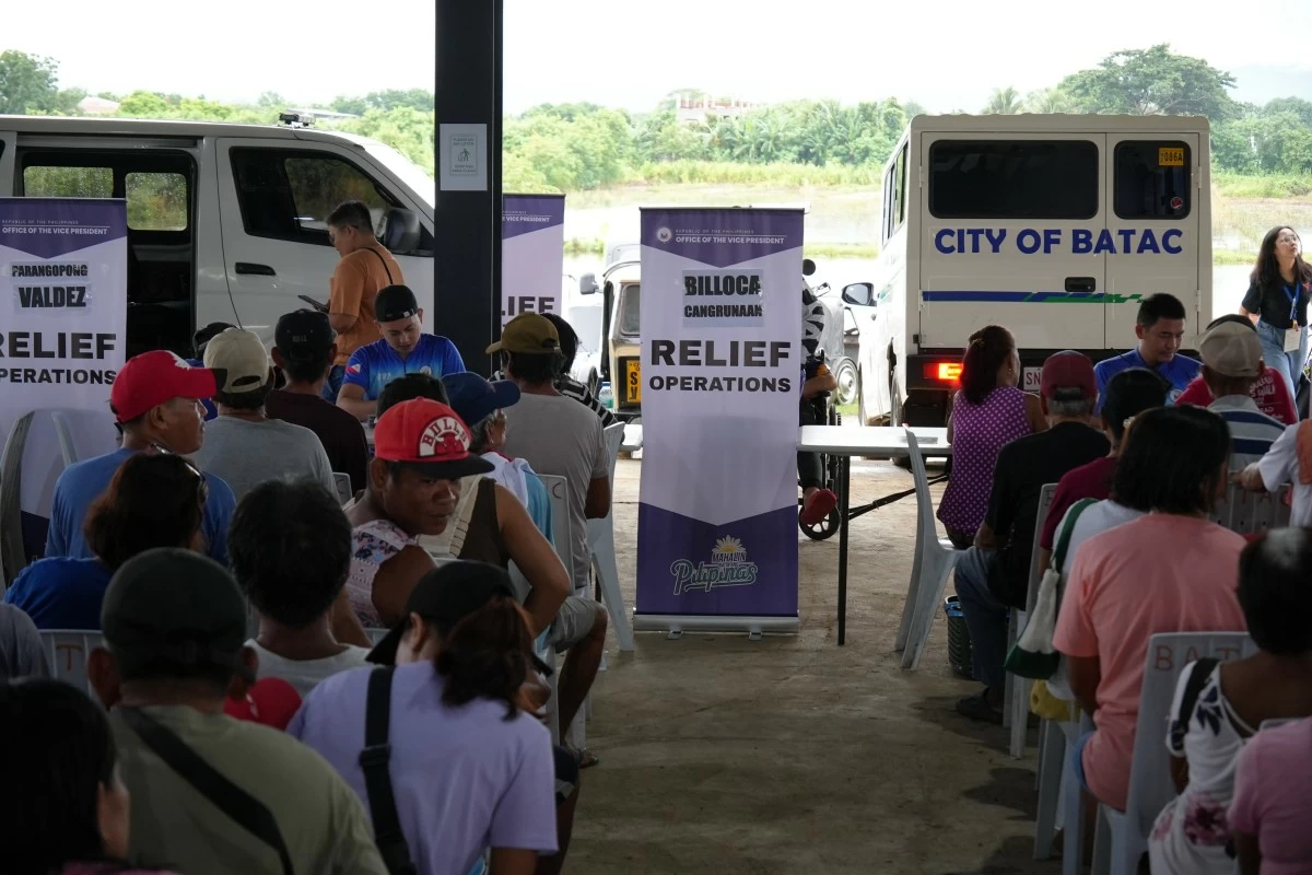 OVP personnel distribute relief assistance to affected families in Batac City, Ilocos Norte, following flooding caused by the southwest monsoon and Tropical Cyclone Kiyapo. (OVP photo)