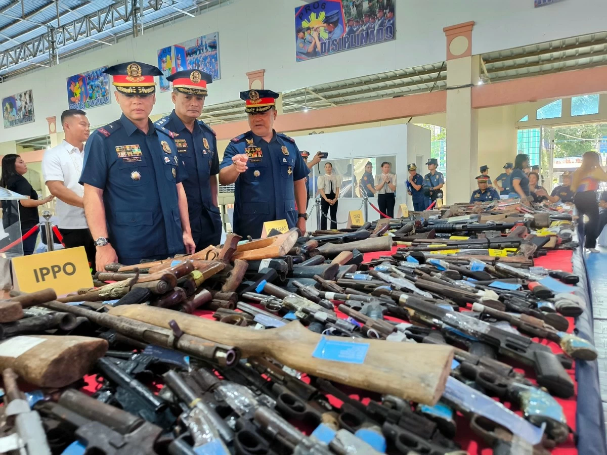 Brigadier General Randulf T. Tuaño inspects firearms recovered across Western Visayas.  (Tara Yap)