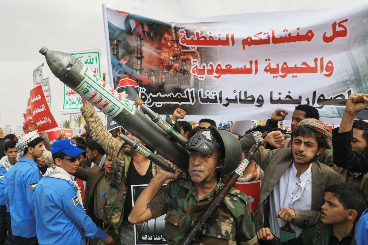 FILE - Houthi supporters hold a rally in Sanaa, Yemen, July 17, 2026, against the Saudi-led coalition. Banner in Arabic reads, 