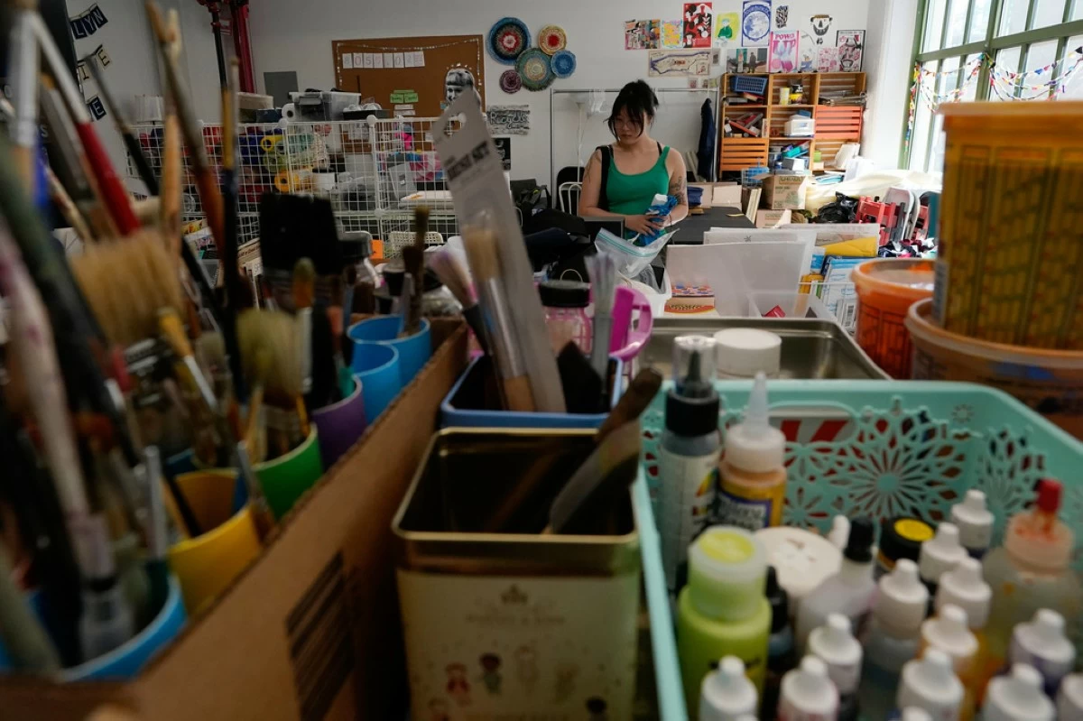 A shopper looks through art supplies for sale at the Brooklyn Creative Reuse on Wednesday, July 29, 2026, in the Brooklyn borough of New York. (AP Photo/Alyssa Goodman)