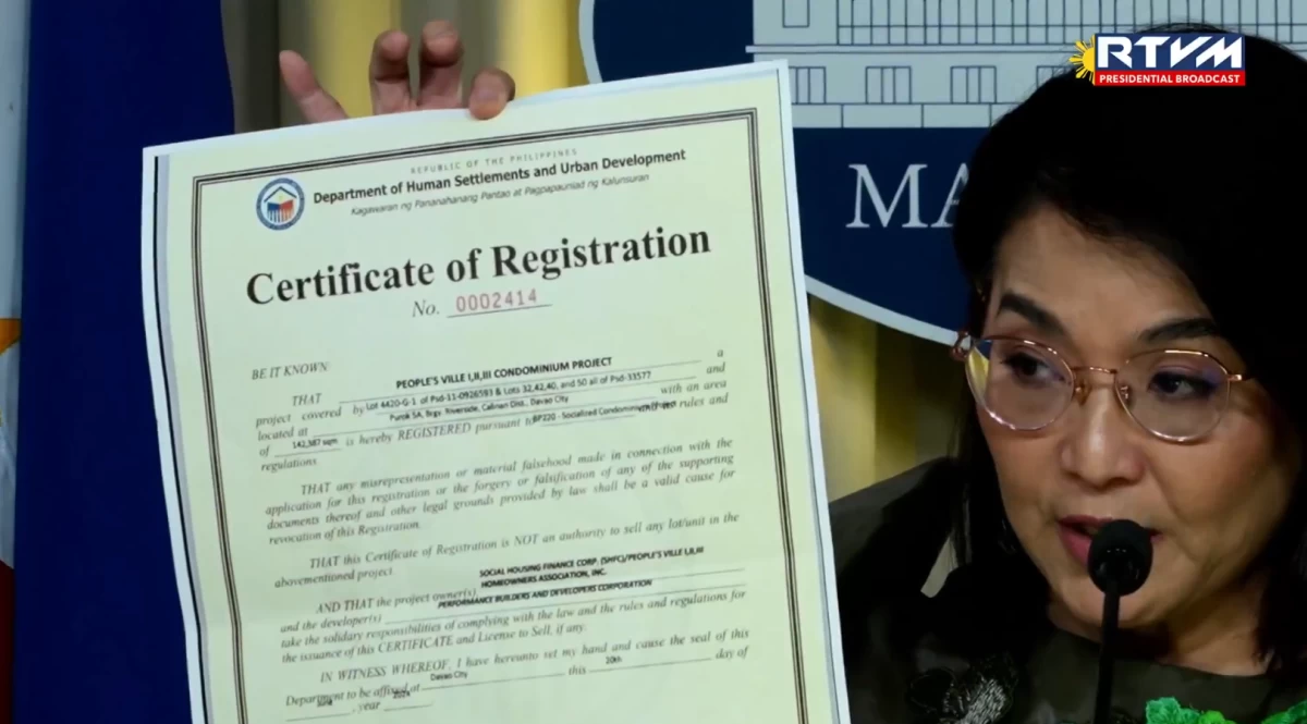 Palace Press Officer and Communications Undersecretary Claire Castro shows a copy of the development permit of the People's Ville housing project in Davao City during a Palace briefing on Aug. 11, 2026. (RTVM)