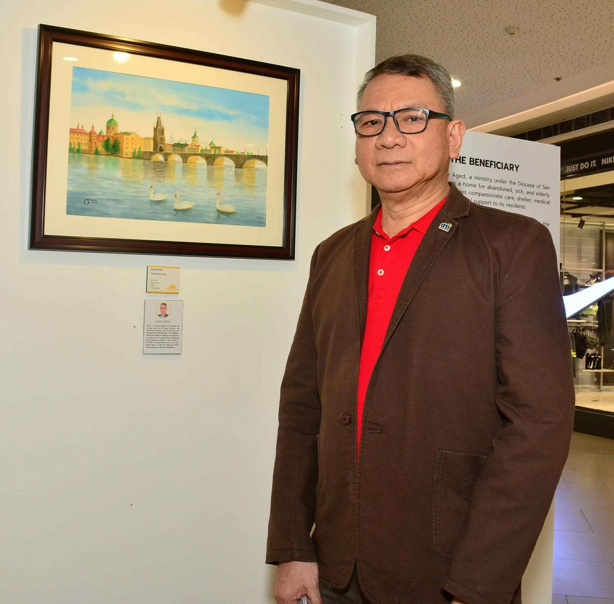 James Empeño beside his watercolor artwork The Bridge (Prague)
