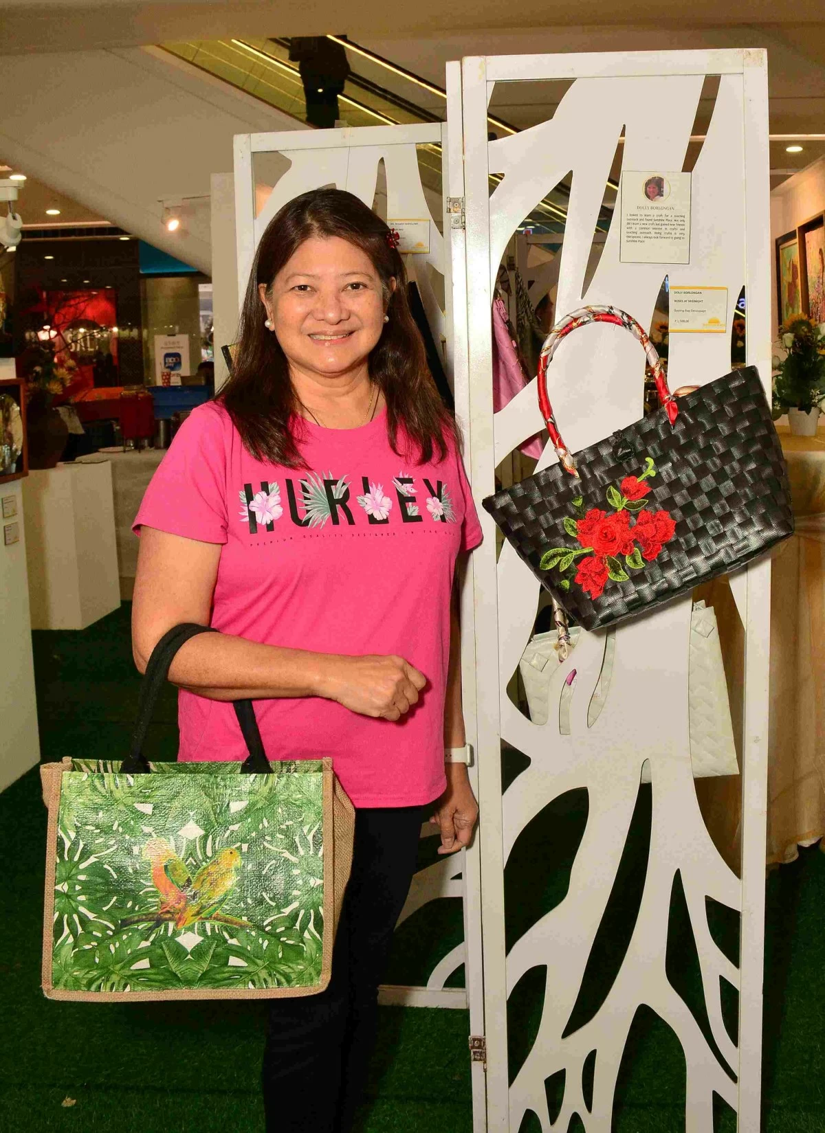 Dolly Borlongan beside her Roses at Midnight bayong decoupage bag