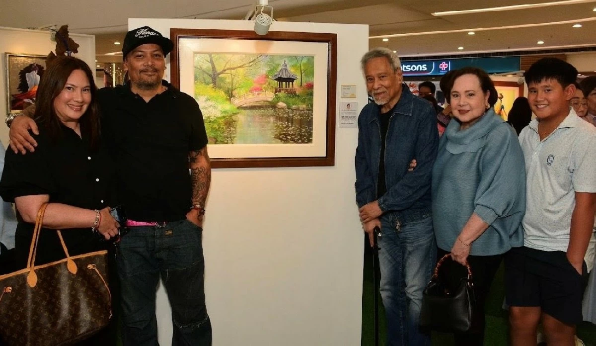 Elena Fernandez beside her Peaceful Garden artwork with her family led by her husband Dr. Manuel Fernandez, Jr.
